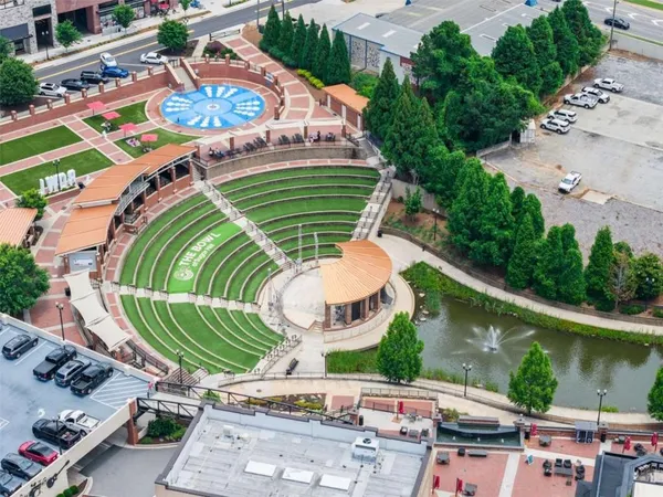 an aerial view of a swimming pool with a patio