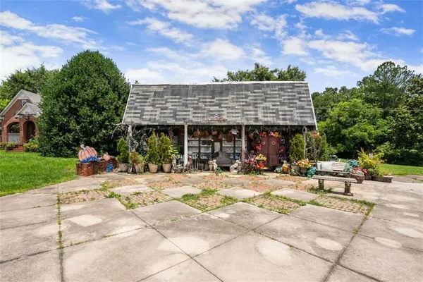 a view of a patio with a table and chairs under an umbrella