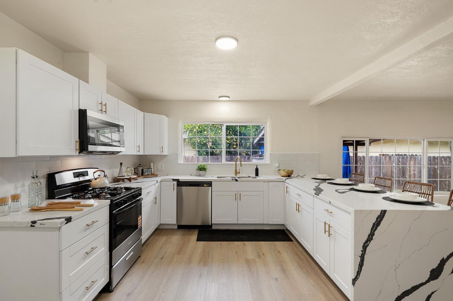 1417 Concord Avenue Modesto, CA 95350 - Photo 13 of 40 a kitchen with stove a sink dishwasher and a refrigerator