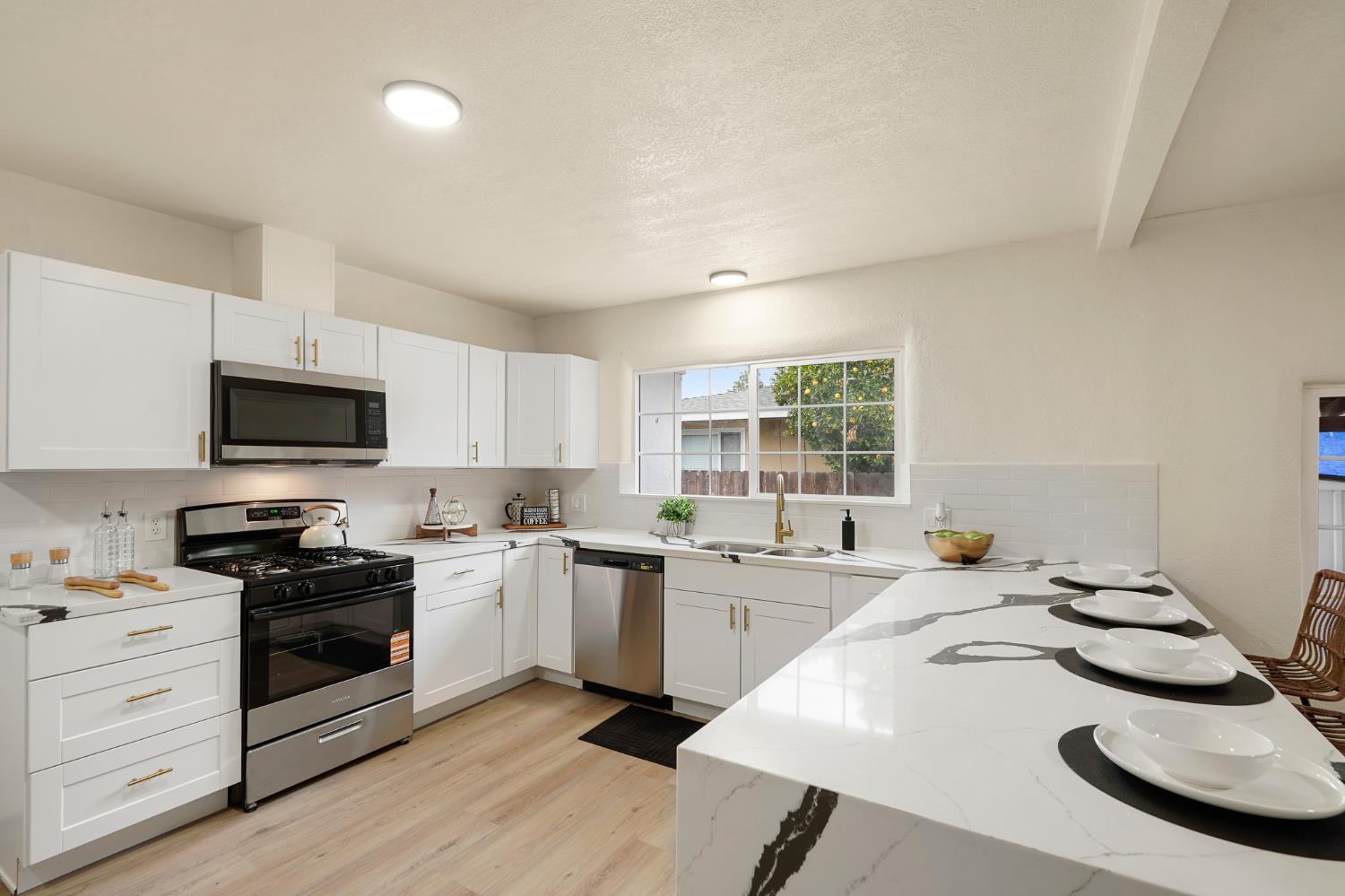 1417 Concord Avenue Modesto, CA 95350 - Photo 15 of 40 a kitchen with a sink a stove and cabinets