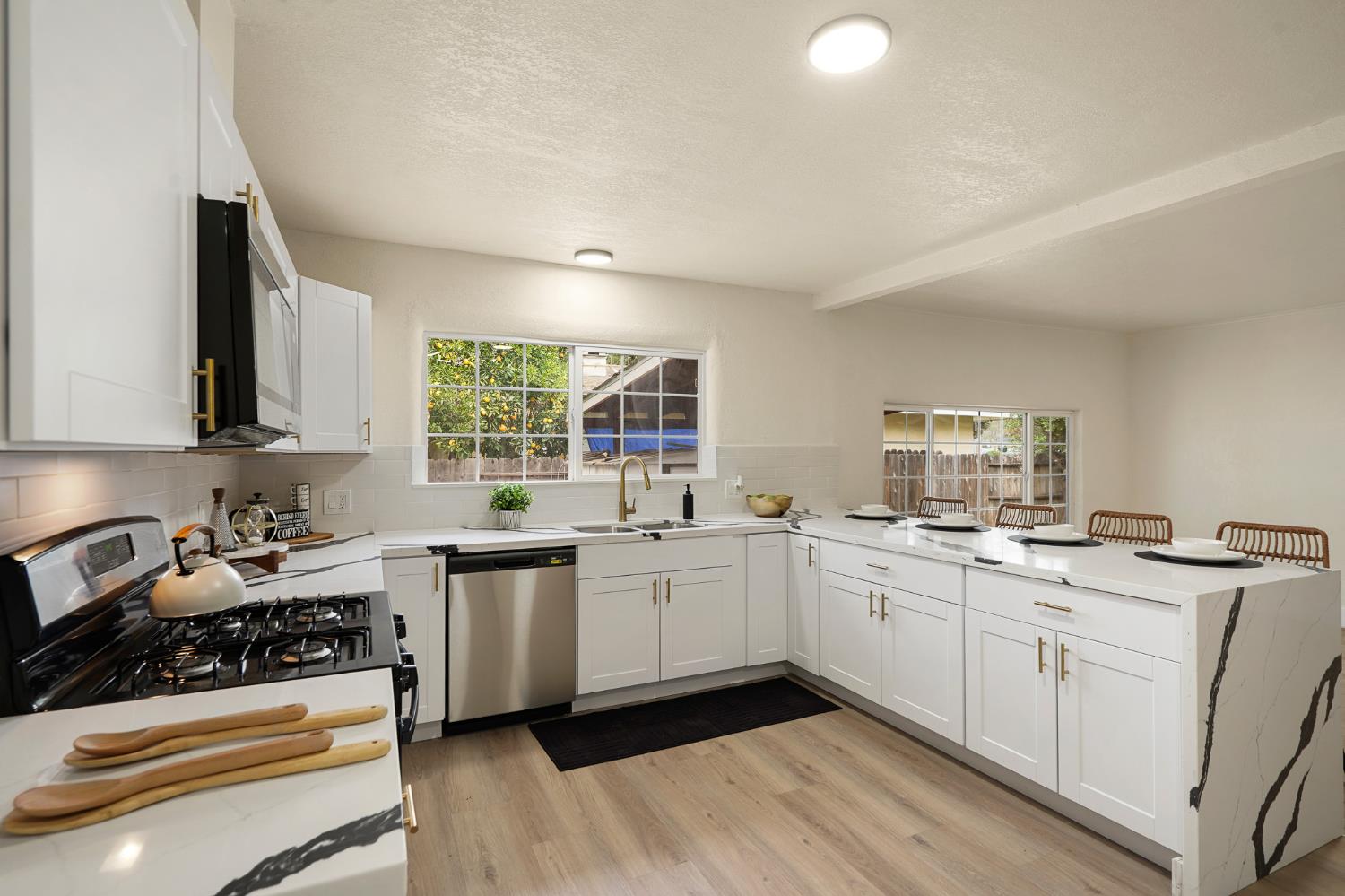 1417 Concord Avenue Modesto, CA 95350 - Photo 17 of 40 a kitchen with sink stove and cabinets
