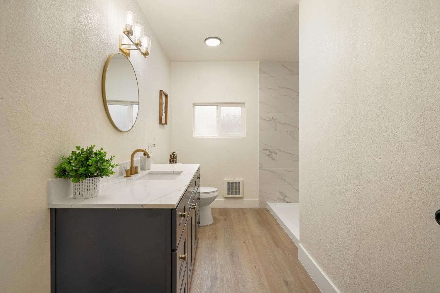 1417 Concord Avenue Modesto, CA 95350 - Photo 23 of 40 a bathroom with a sink and a mirror