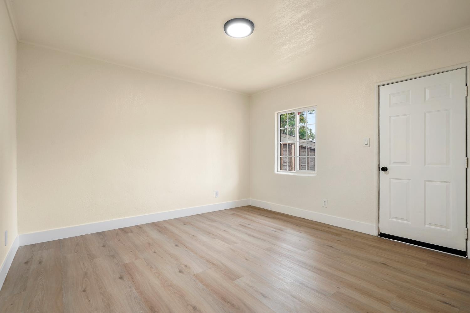 1417 Concord Avenue Modesto, CA 95350 - Photo 29 of 40 wooden floor in an empty room with a window
