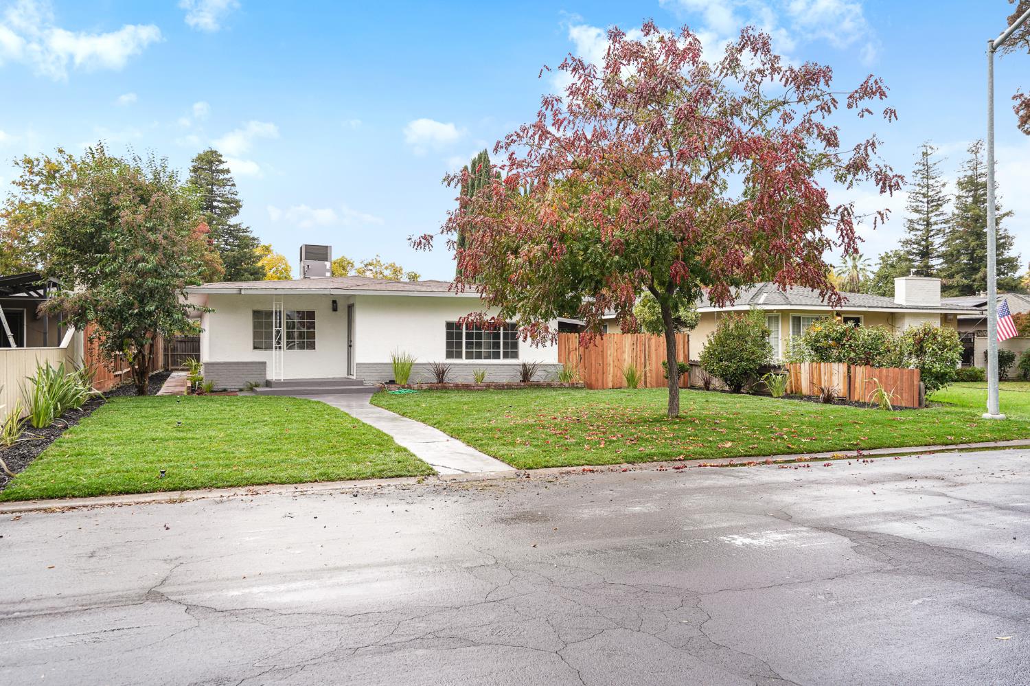1417 Concord Avenue Modesto, CA 95350 - Photo 4 of 40 a view of a house next to a yard and large trees