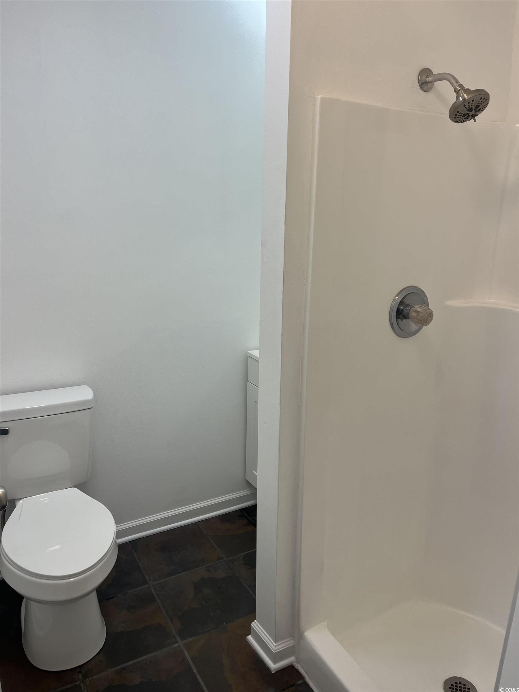 600 65th Avenue North, Unit 7 Myrtle Beach, SC 29572 - Photo 11 of 29 Full bath featuring a stall shower and dark tile patterned flooring