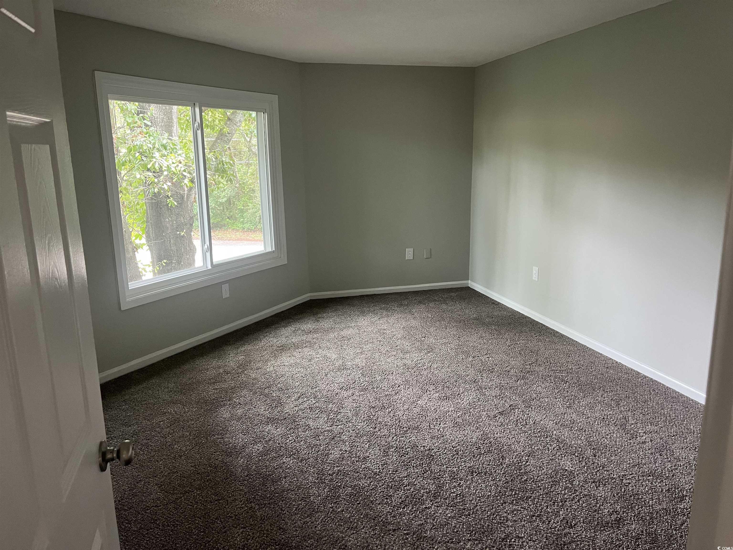 600 65th Avenue North, Unit 7 Myrtle Beach, SC 29572 - Photo 16 of 29 Unfurnished room with carpet flooring and baseboards