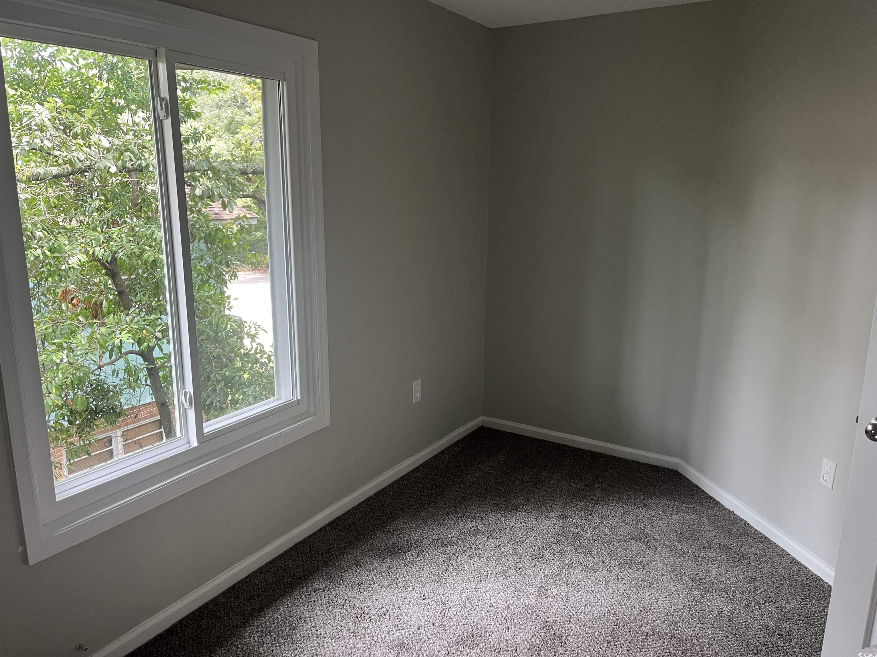 600 65th Avenue North, Unit 7 Myrtle Beach, SC 29572 - Photo 20 of 29 Unfurnished room featuring carpet floors and baseboards