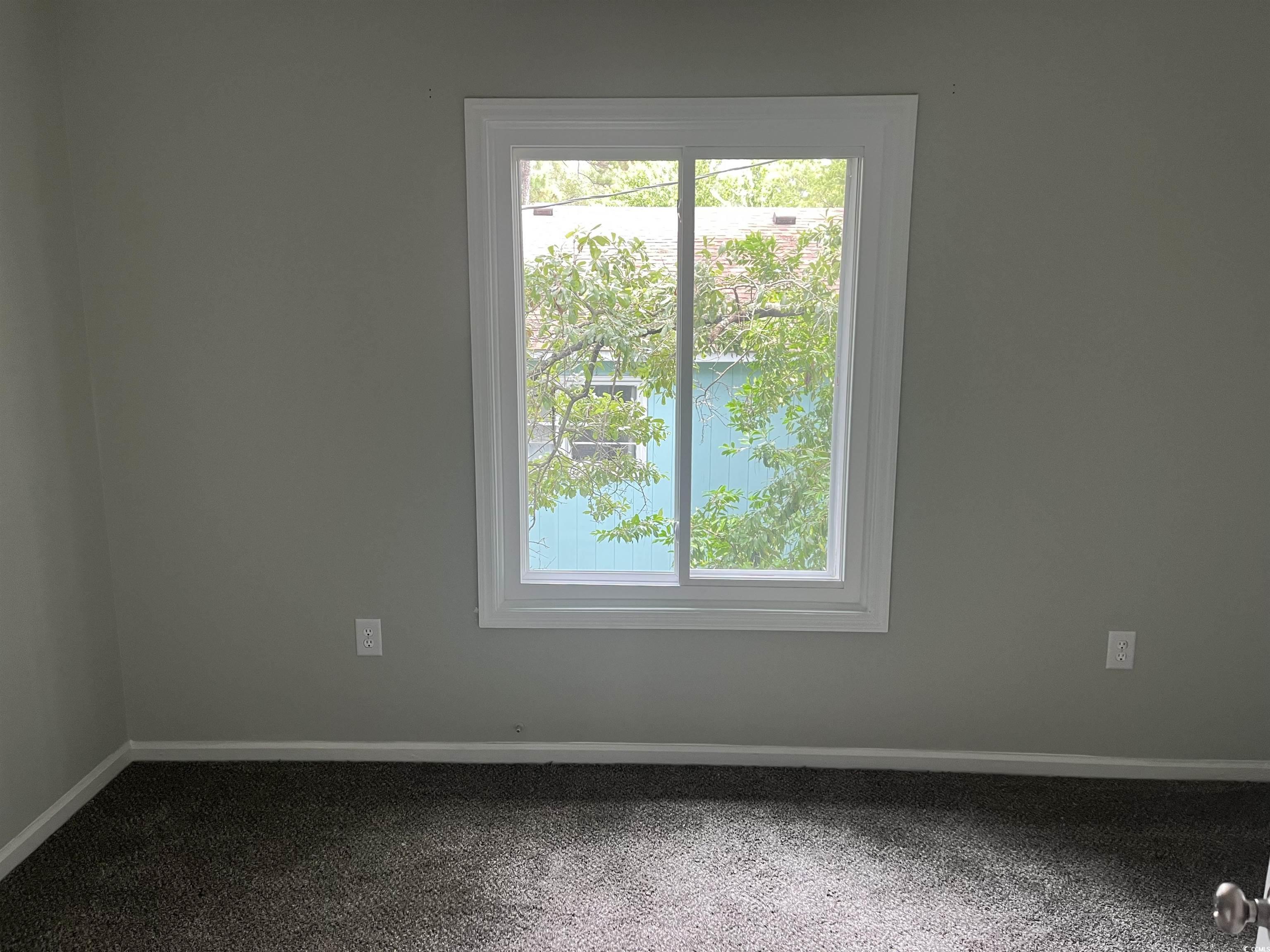 600 65th Avenue North, Unit 7 Myrtle Beach, SC 29572 - Photo 21 of 29 Empty room featuring carpet and a water view