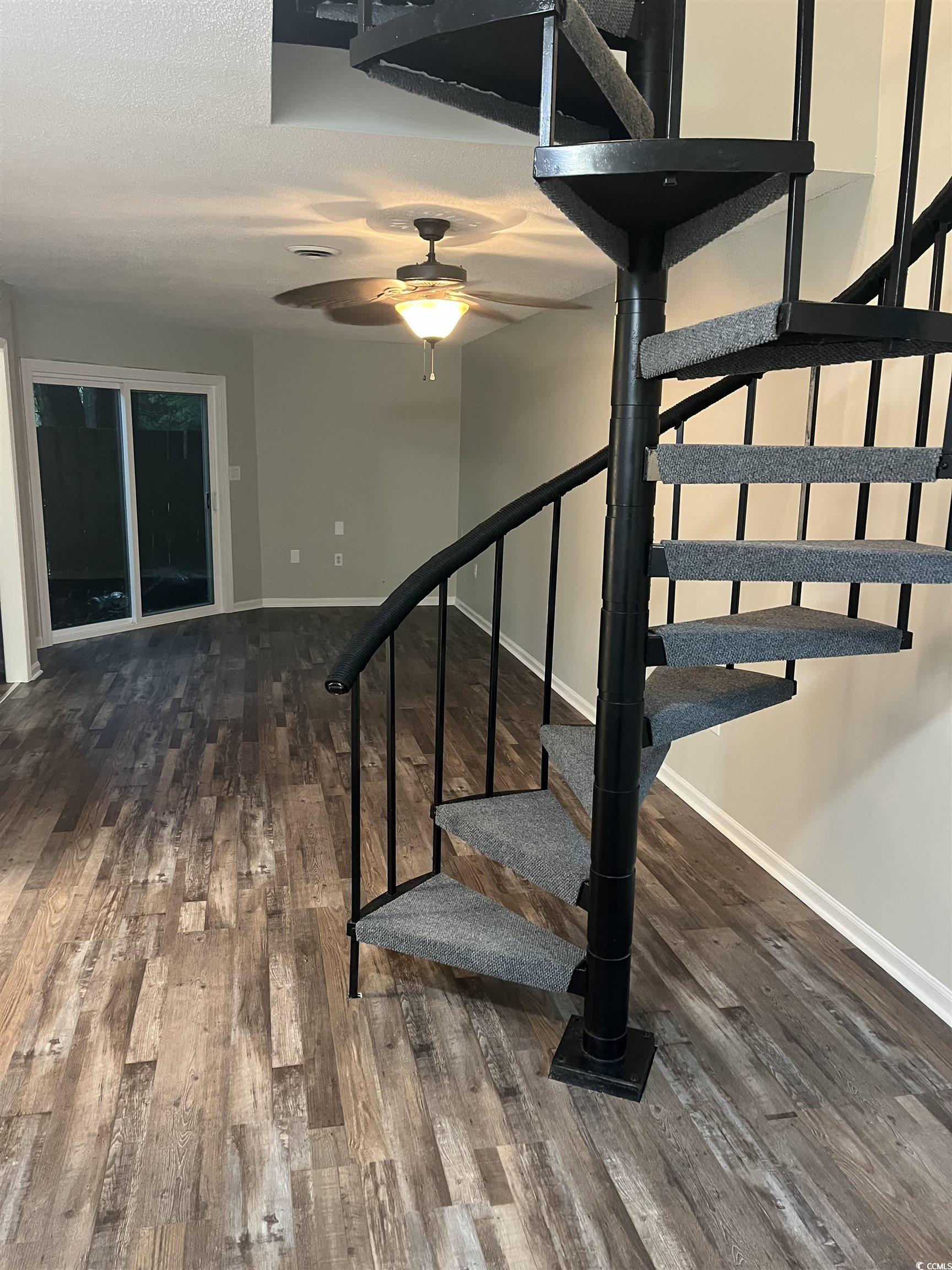 600 65th Avenue North, Unit 7 Myrtle Beach, SC 29572 - Photo 3 of 29 Staircase featuring wood finished floors, ceiling fan, and a textured ceiling