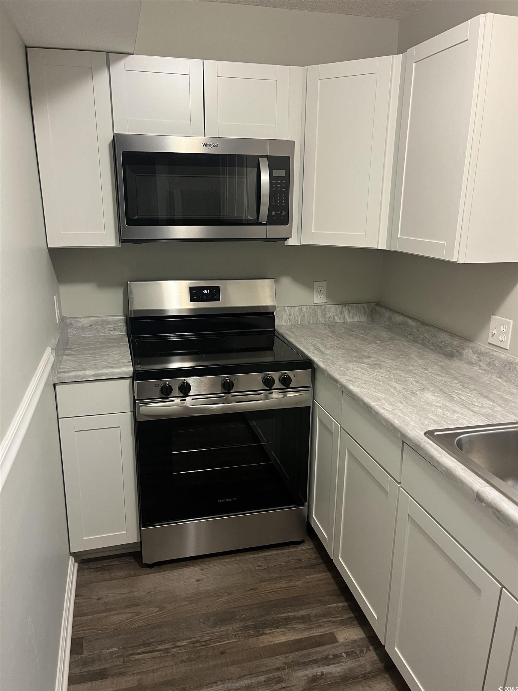 600 65th Avenue North, Unit 7 Myrtle Beach, SC 29572 - Photo 9 of 29 Kitchen with stainless steel appliances and white cabinets