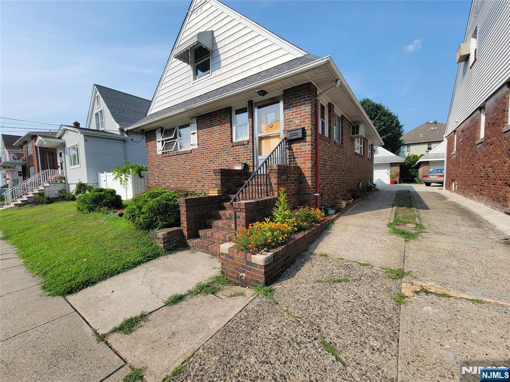 a front view of a house with a garden