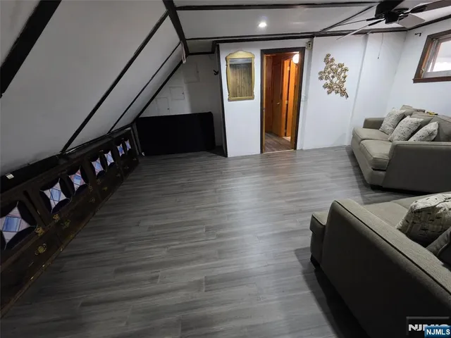 a living room with furniture and stairs