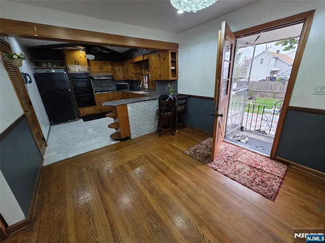 a view of a hallway with stairs and a chandelier