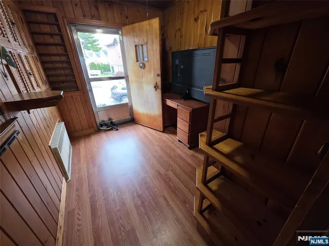 a view of a room with wooden floor and window