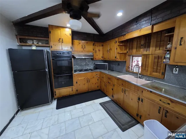 a bedroom with a bed and a flat tv screen on dresser