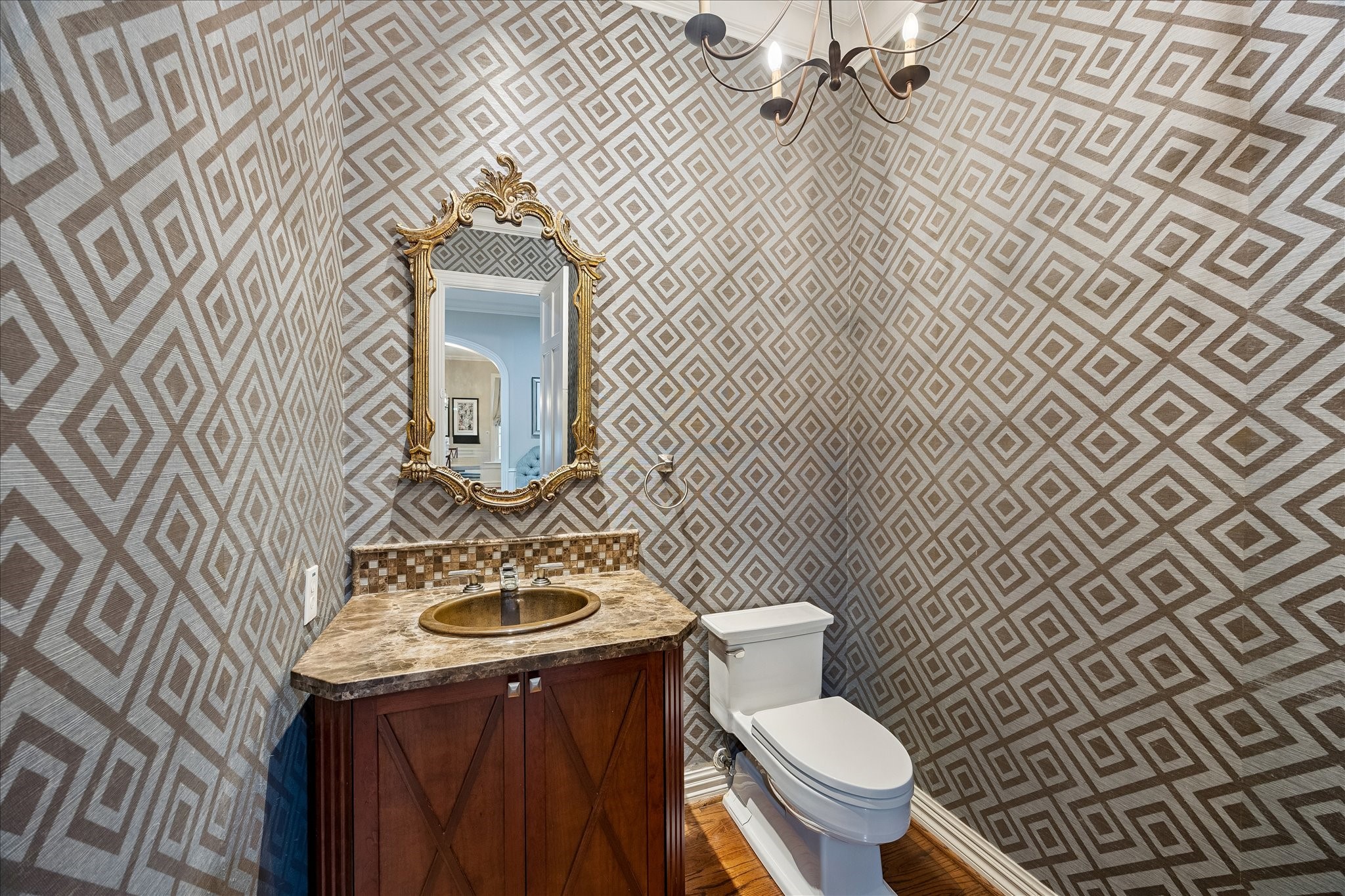 6358 Auden Street Houston, TX 77005 - Photo 17 of 50 a bathroom with a toilet a sink and mirror