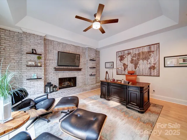 a living room with furniture fireplace and flat screen tv