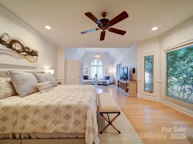 a bed room with a bed mirror and a window