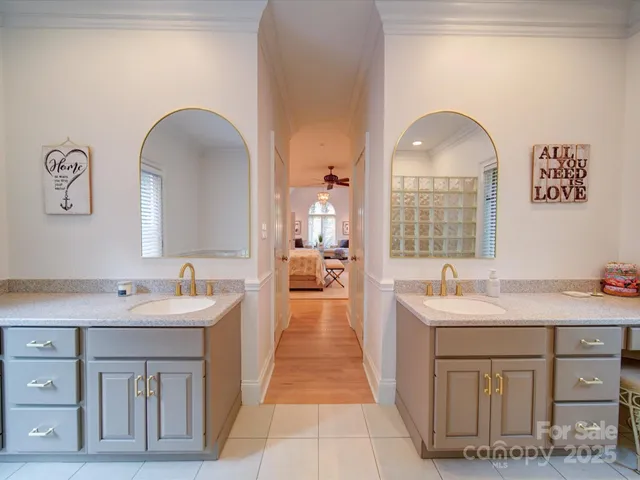 a en suite bathroom with a double vanity sink and a mirror
