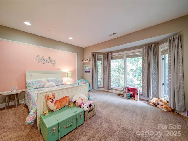 a bedroom with furniture and a large window