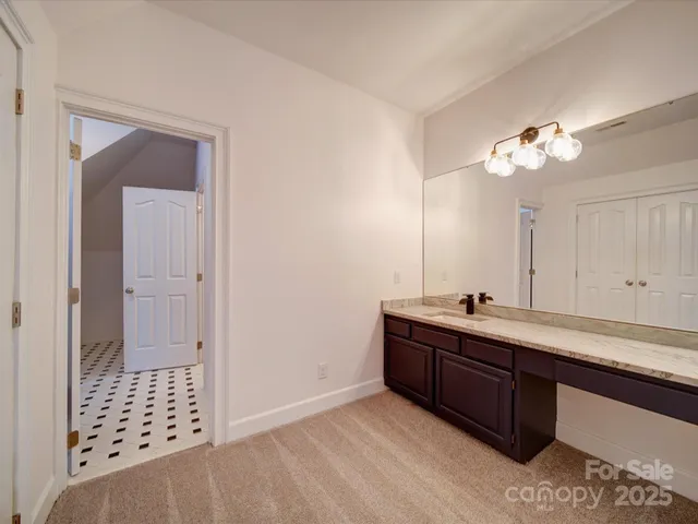 a room with a sink vanity and mirror