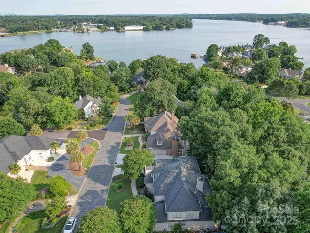 an aerial view of a house with outdoor space and lake view