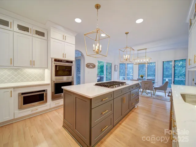 a kitchen with stove a sink and refrigerator