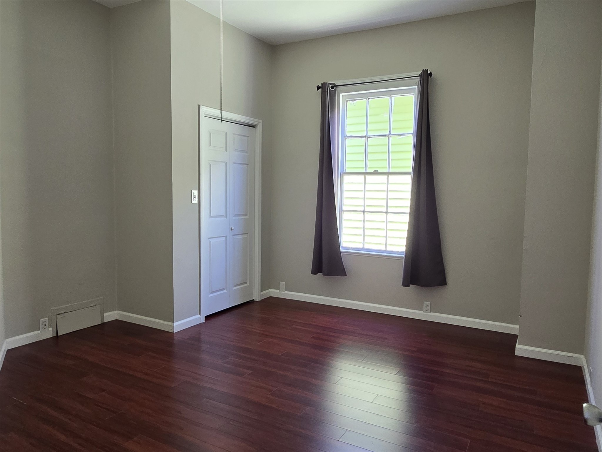 1614 Market Street, Unit 2 Galveston, TX 77550 - Photo 13 of 22 an empty room with wooden floor and windows