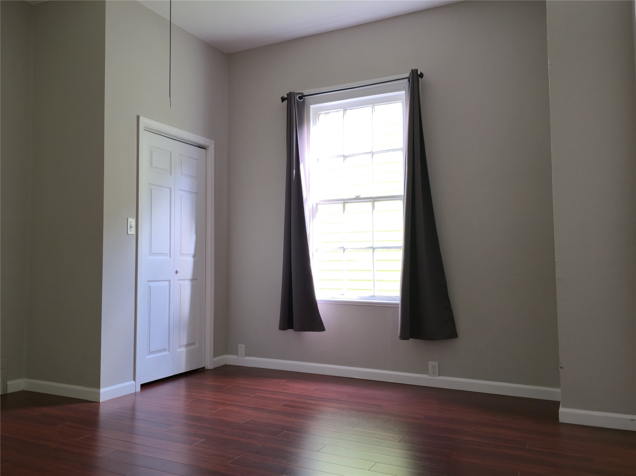 1614 Market Street, Unit 2 Galveston, TX 77550 - Photo 14 of 22 a view of an empty room with wooden floor and a window