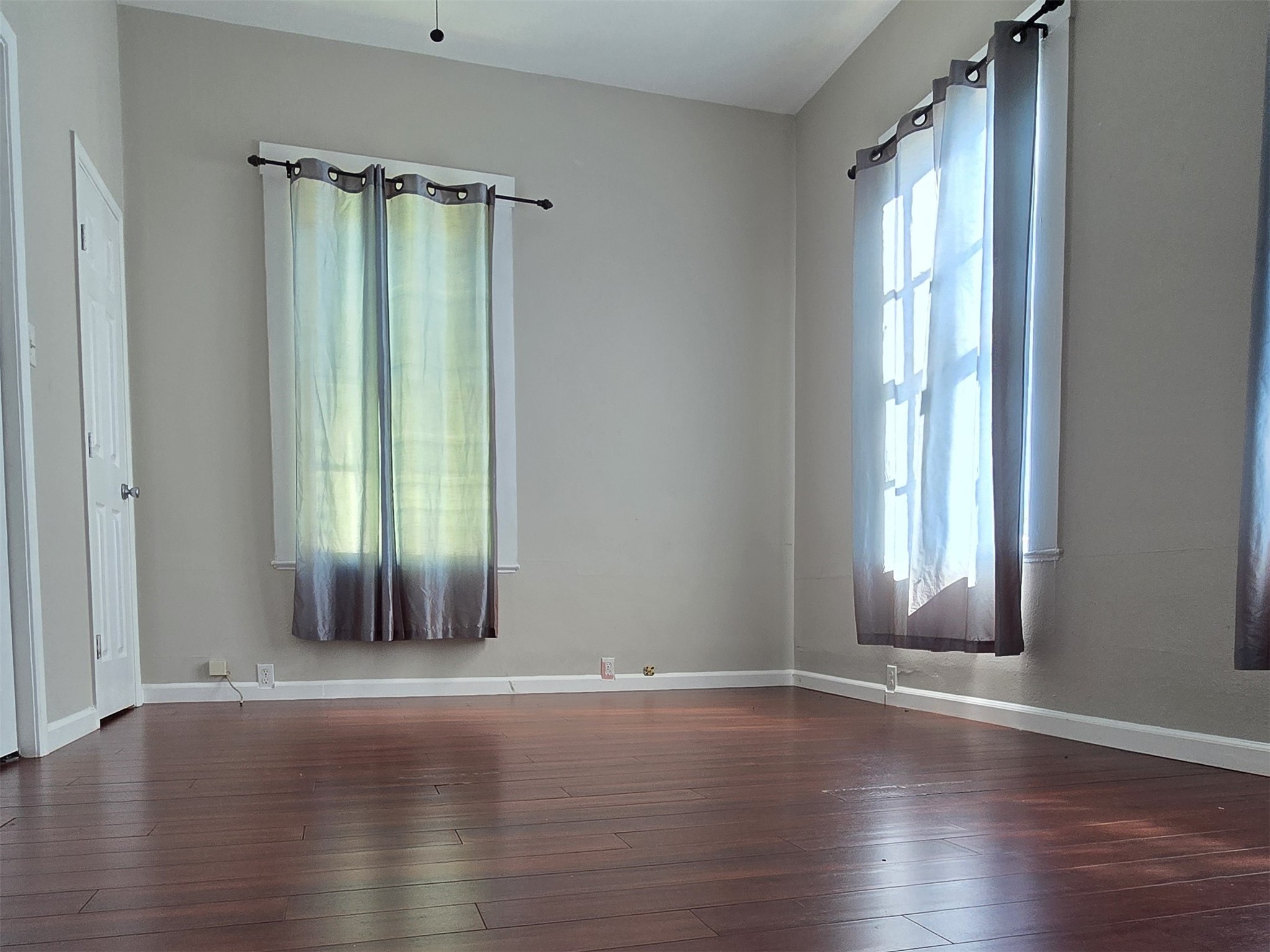 1614 Market Street, Unit 2 Galveston, TX 77550 - Photo 16 of 22 an empty room with wooden floor and windows