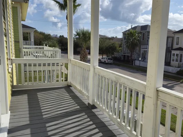 a view of a balcony with wooden floor