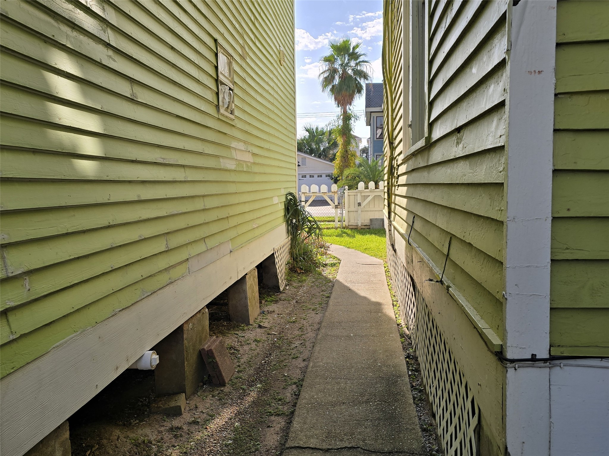 1614 Market Street, Unit 2 Galveston, TX 77550 - Photo 3 of 22 a view of a pathway with a wooden fence