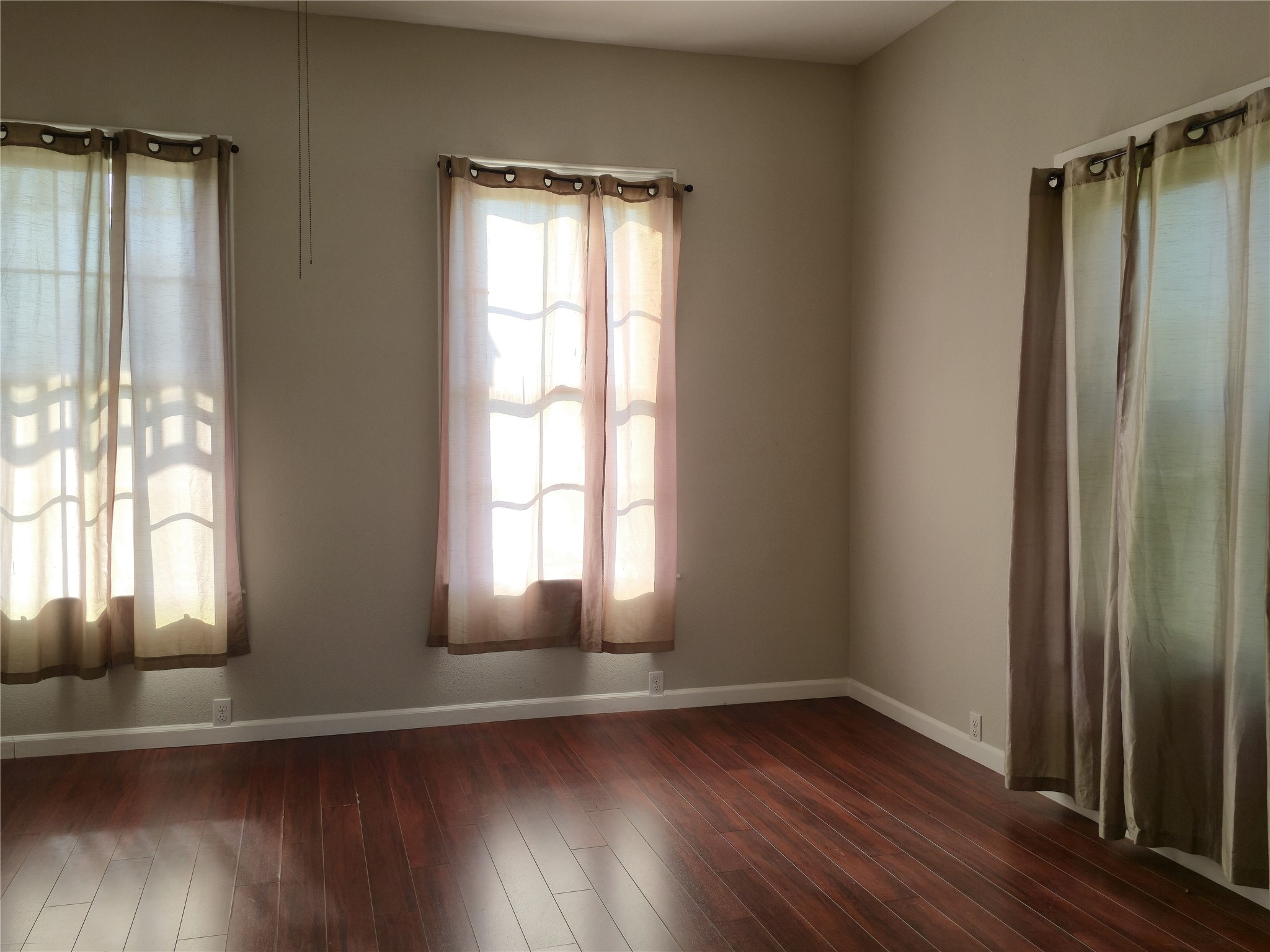 1614 Market Street, Unit 2 Galveston, TX 77550 - Photo 7 of 22 an empty room with wooden floor and windows