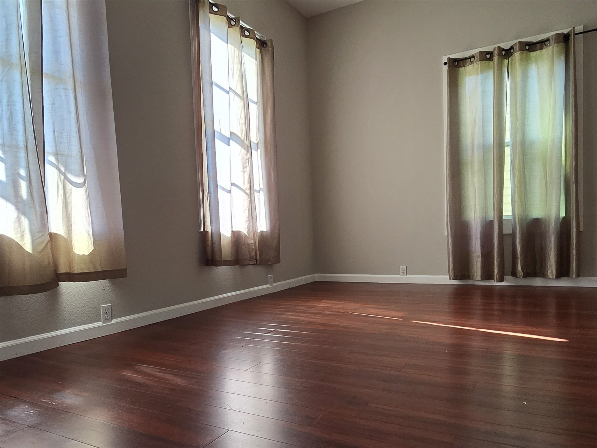 1614 Market Street, Unit 2 Galveston, TX 77550 - Photo 8 of 22 an empty room with wooden floor and windows