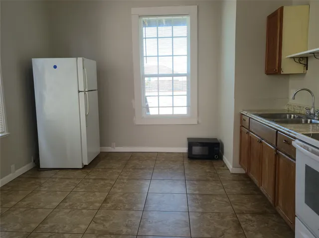 a kitchen with a refrigerator and a stove