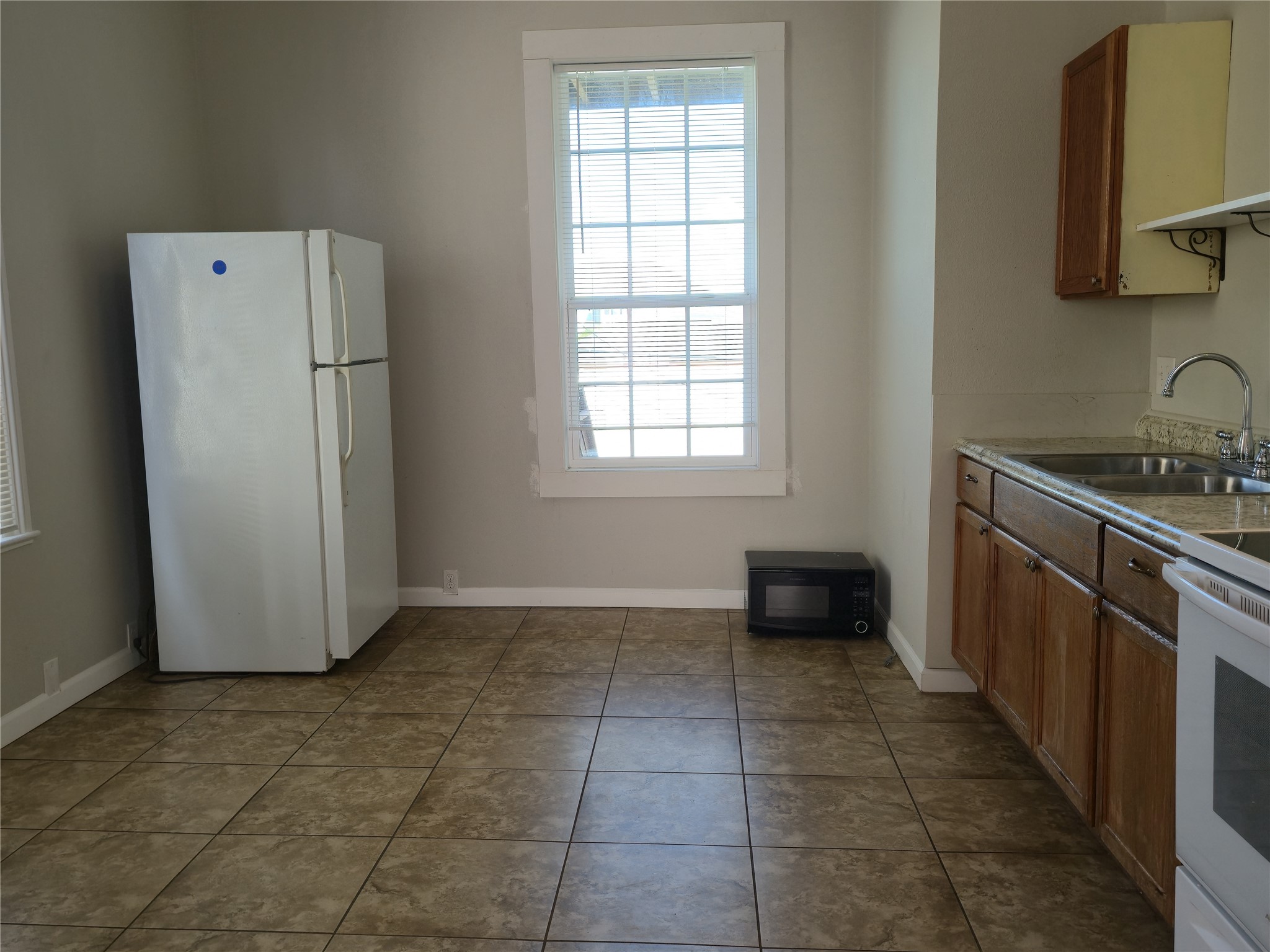1614 Market Street, Unit 2 Galveston, TX 77550 - Photo 10 of 22 a kitchen with a refrigerator and a stove