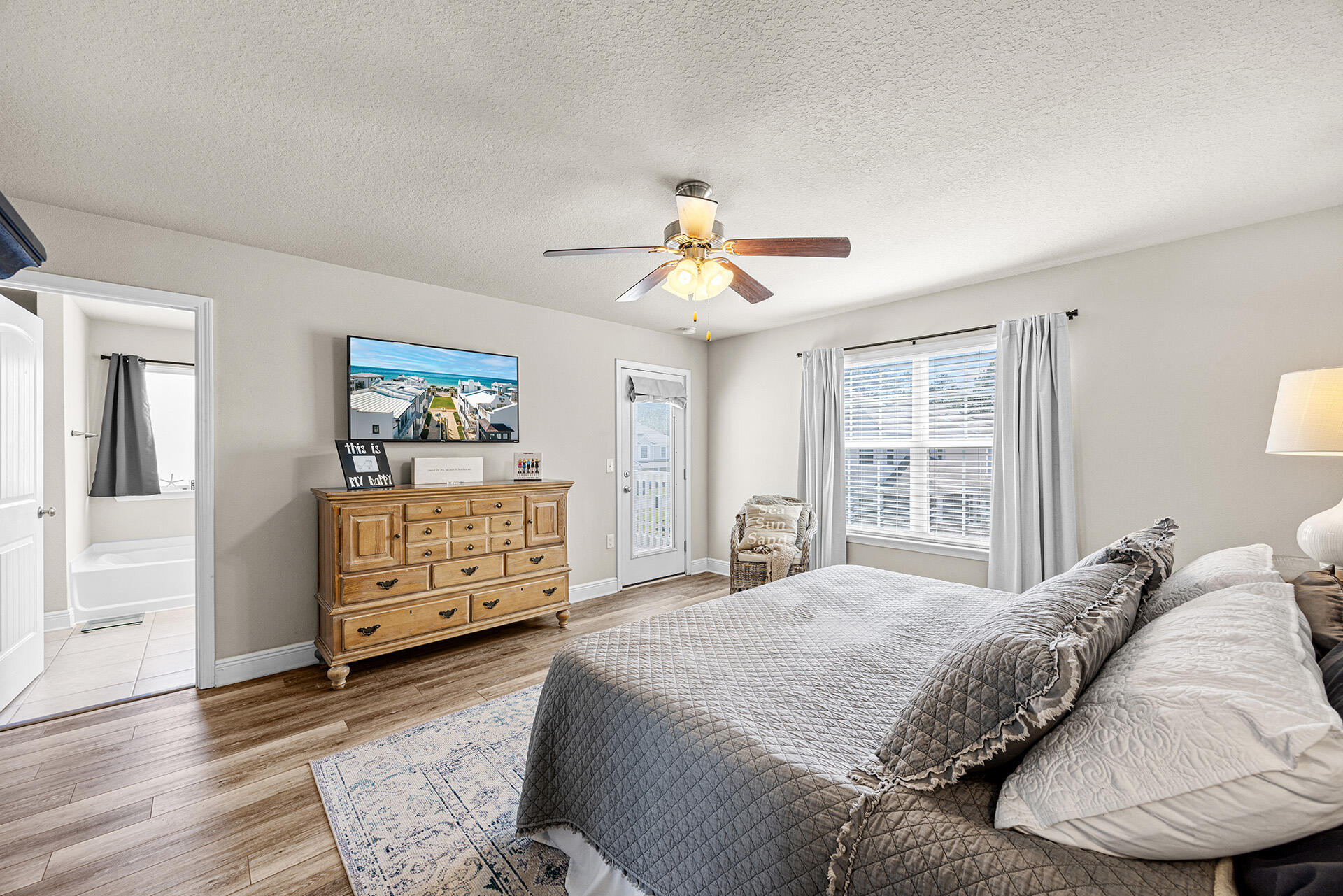 52 Tranquility Lane Santa Rosa Beach, FL 32459 - Photo 22 of 31 a bedroom with a bed a dresser and a chandelier