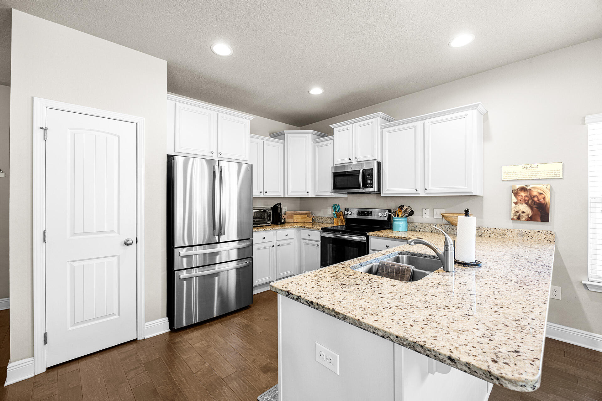52 Tranquility Lane Santa Rosa Beach, FL 32459 - Photo 29 of 31 a kitchen with granite countertop a refrigerator a sink a stove a microwave and island