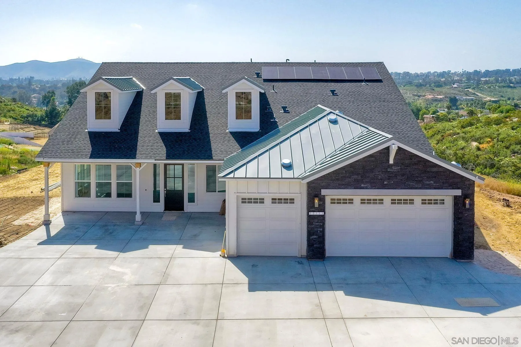a front view of a house with a garage