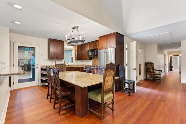 a view of a a dining room with furniture window and wooden floor