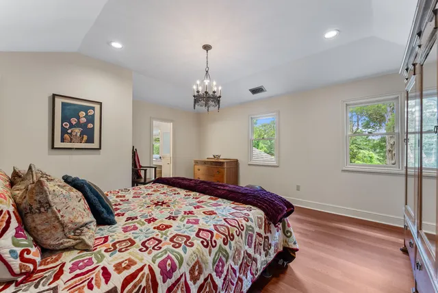 a bedroom with bed and windows