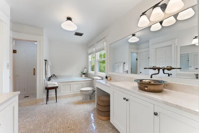 a bathroom with a double vanity sink and a bathtub