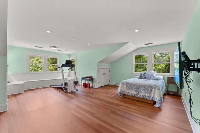 a living room with furniture gym equipment and a large window