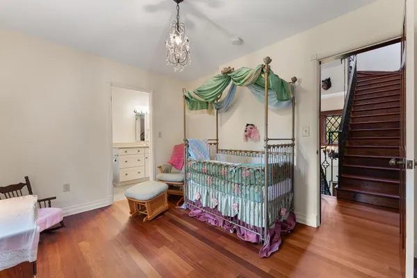a living room with a bed and a book shelf