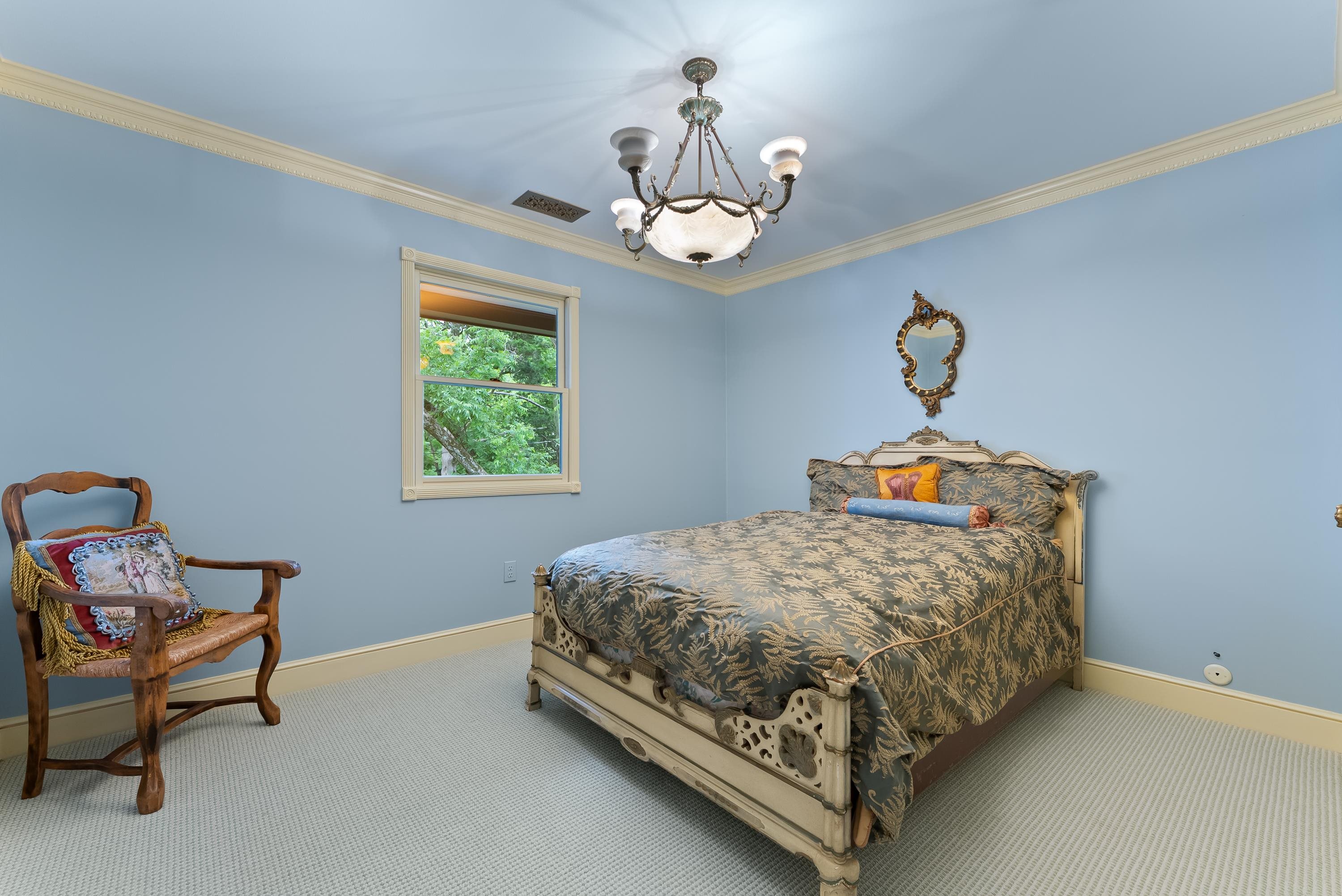 470 Losch Way Somerville, TN 38068 - Photo 18 of 40 a bedroom with a bed and a chandelier
