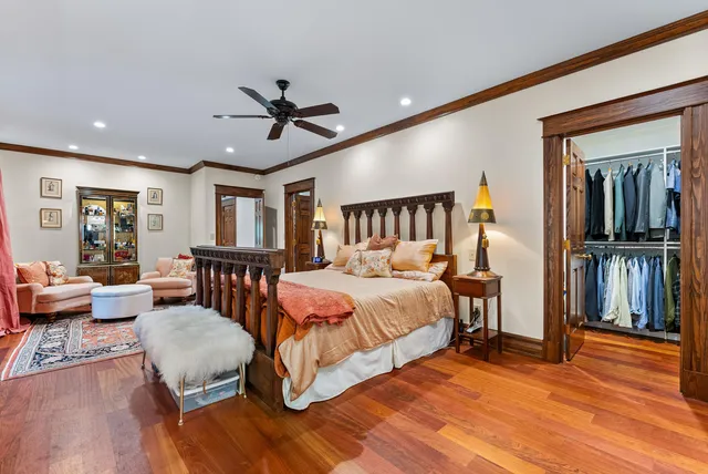 a spacious bedroom with a bed a couch and a dresser in it