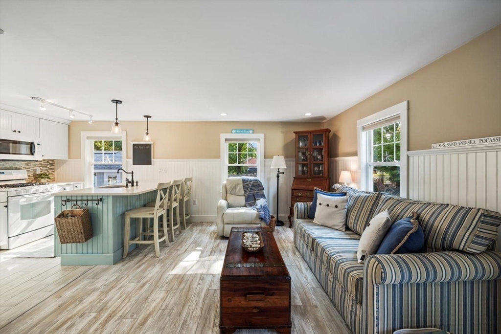 2 River Road Pocasset, MA 02559 - Photo 17 of 37 a living room with furniture a dining table and kitchen view