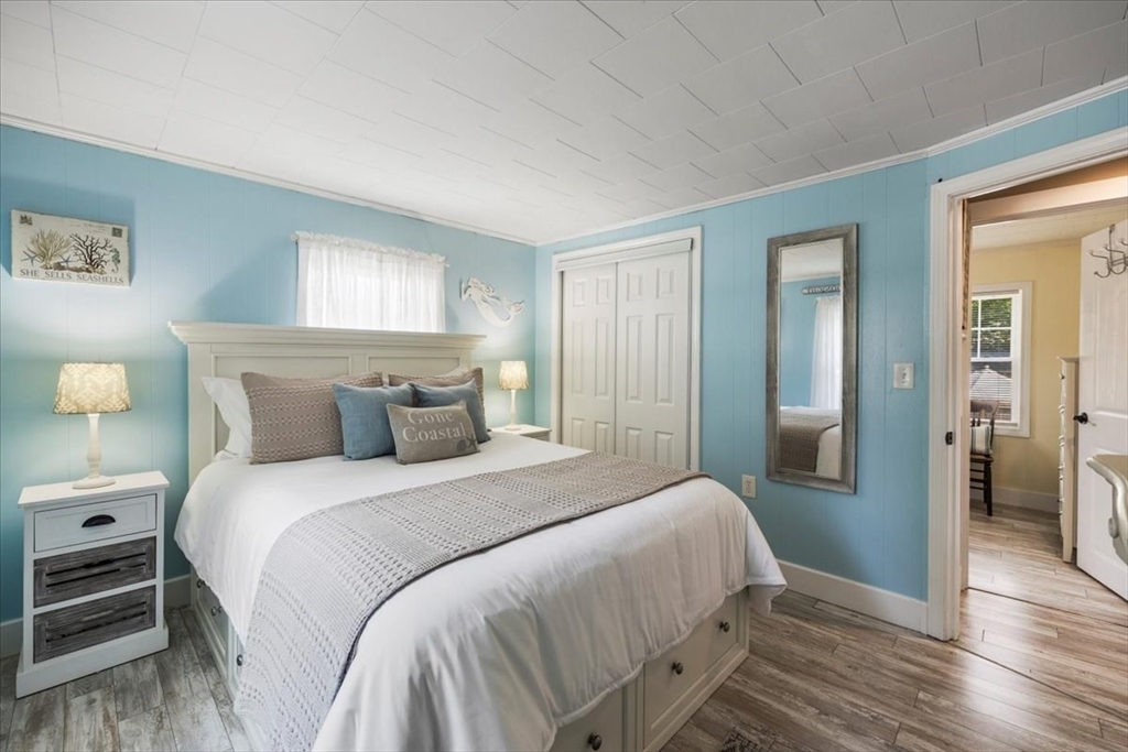 2 River Road Pocasset, MA 02559 - Photo 23 of 37 a bedroom with a bed and wooden floor