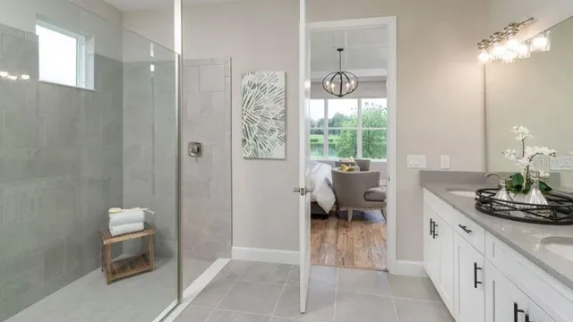 a bedroom with a bed a mirror and a large window