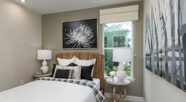 a living room with furniture potted plant and a large window